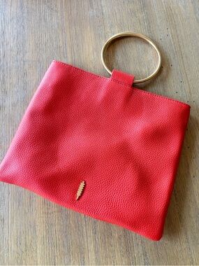 Thacker orange red leather crossbody bag with gold ring handle